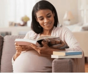 a pregnant lady reading a book